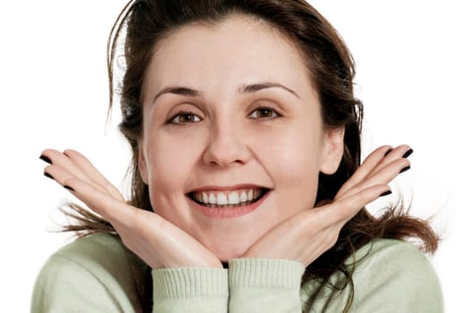 Happy young woman smiling with friendly look,hands on chin