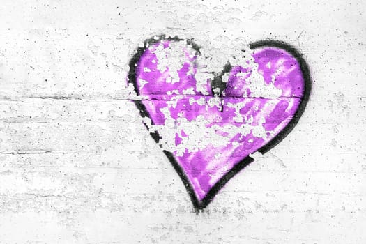 Painted violet abstract heart shape love symbol, dirty wall background, metaphor to urban and romantic valentine, grunge style.