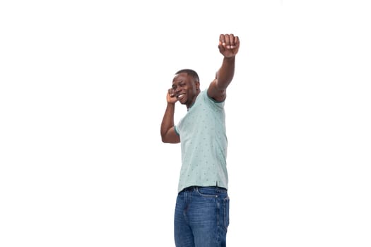 young slender american man dressed in a t-shirt feels joy.