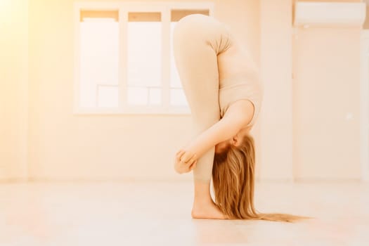 Group of young womans fitness instructor in Sportswear Leggings and Tops, stretching in the gym before pilates, on a yoga mat near the large window on a sunny day, female fitness yoga routine concept.