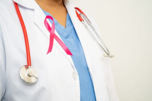 Breast cancer, Asian doctor woman with pink ribbon, symbol of World Breast Cancer Day.