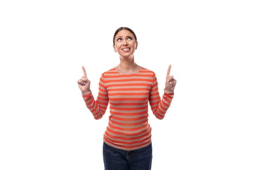 a young well-groomed adult woman dressed in an orange striped jacket attracts attention and talks about an idea.