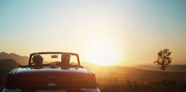 Back, sunset and a senior couple on a road trip in a convertible car for travel, freedom or adventure together. Love, mockup or view of nature with an elderly man and woman in a vehicle for a drive.