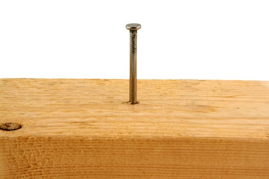 A Ten penny nail in a peice of wood