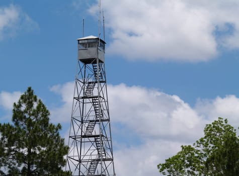 Fire lookout tower in south Georgia against a beautiful blue sky.