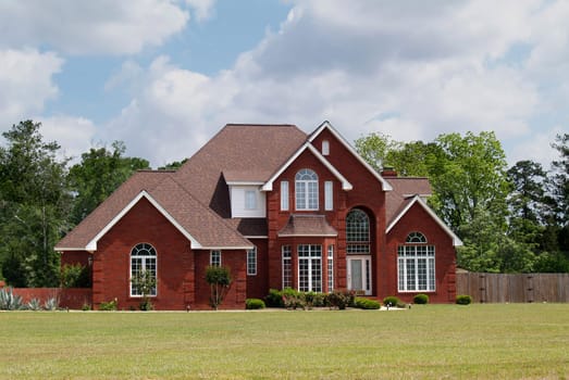 Two story residential home with brick facade.