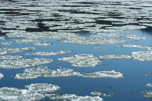 A Frozen river with icy patches