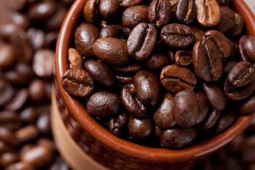 Close-up of coffee beans in a cup. Studio shot.