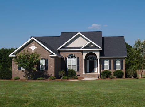 One story new brown brick residential home.