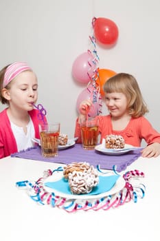 Girls having a traditional finnish May Day celebration, eating funnel cake, tippaleipa and drinking mead, sima
