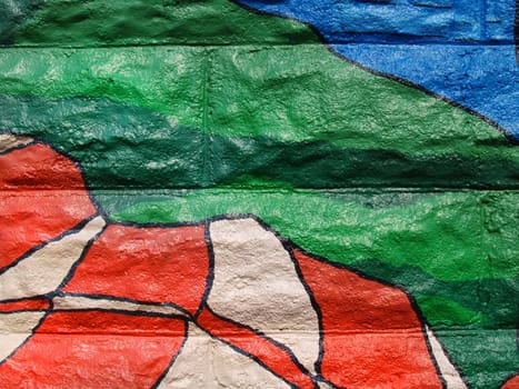 Close-up of colorful graffiti in shades of green, blue and orange that can be used as a background, taken from a public building in Carmel, Indiana.