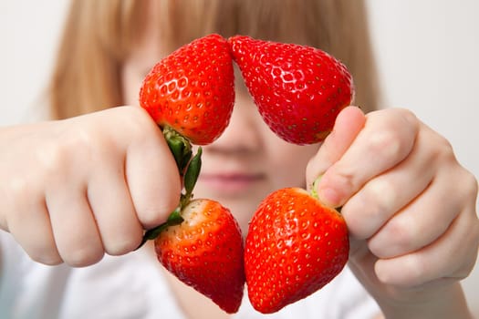 Little girl with beautiful ripe strawberries. Studio shot.