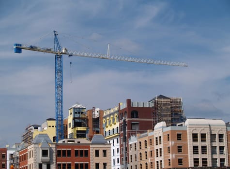 Huge crane on top of a newly constructed building.