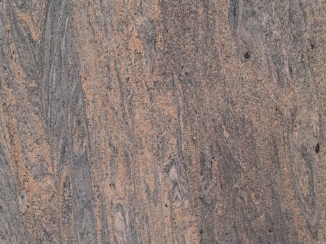 Marbled grained texture with a vertical grain in gray and tan colors.