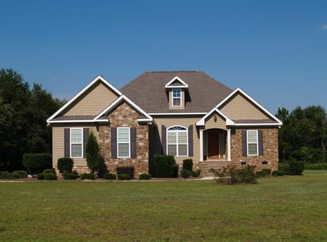 Single story stone and vinyl residential home.