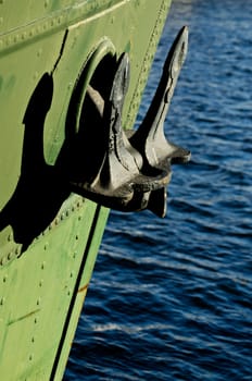 a close up of an anchor on a green boat