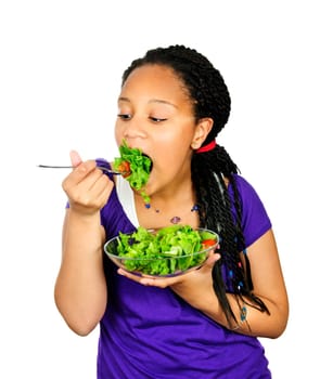Isolated portrait of black teenage girl eating salad