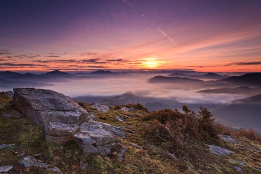 Mountains over the fog in the winter sunrise, Bizkaia, Spain