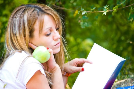 beautiful young woman working out with laptop and reading books