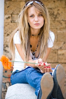 beautiful young woman with books and flower outdoor