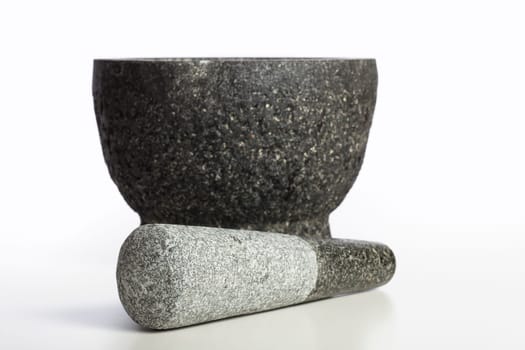 Granite mortar and pestle isolated on white background.