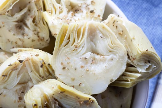 Artichoke hearts covered in herbs served as an appetizer
