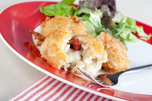 Fresh risotto balls filled with cheese and sun dried tomatoes.