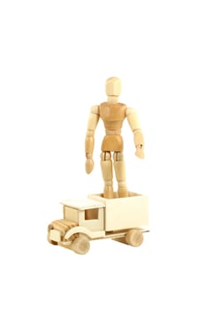A Wooden manikin standing on truck