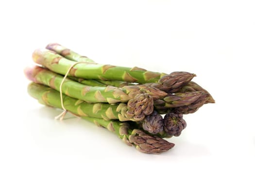 a bunch of green asparagus against a white background