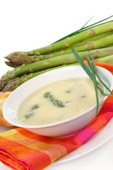 a bowl of asparagus cream soup with fresh ingredients