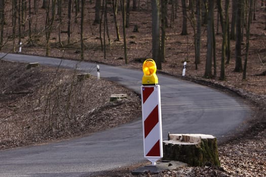 Warning beacon on a road