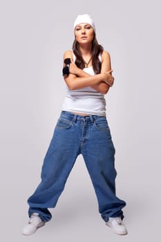 Young beauty tomboy stand in hip-hop style cloth