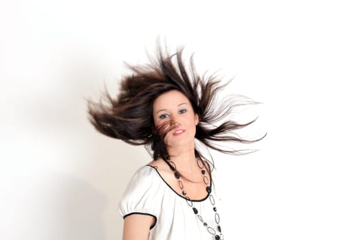 Young pretty teenage girl brunette in studio with long hair