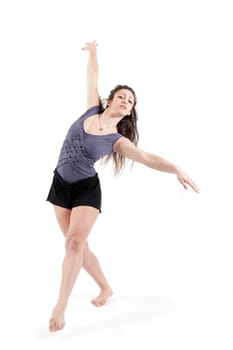 Young pretty teenage girl brunette dancing in studio with long hair
