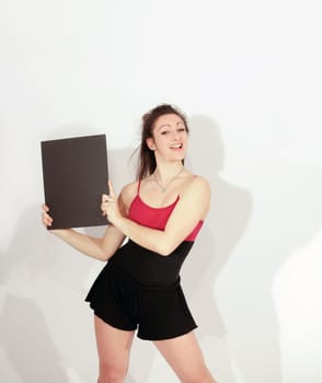 Young pretty teenage girl brunette in studio with long hair showing a blank card