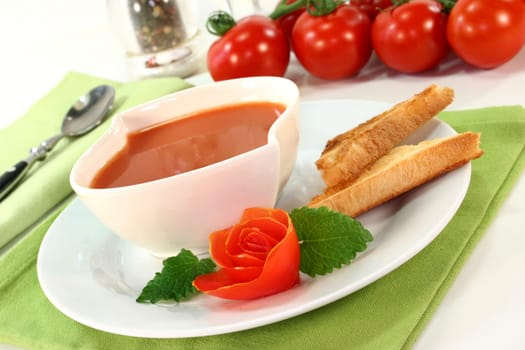 a bowl of tomato cream soup with toast