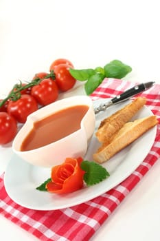 a bowl of tomato cream soup with toast