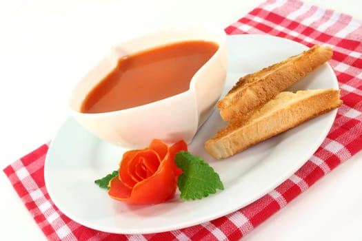 a bowl of tomato cream soup with toast