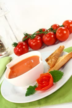 a bowl of tomato cream soup with toast