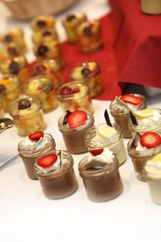 delicious desserts at the buffet - chocolate pudding with strawberry and cream