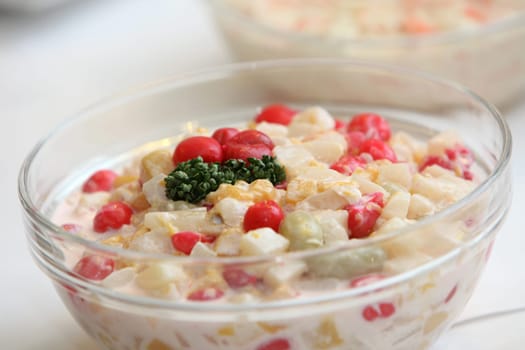 Fresh salad with different ingredients in a glass bowl