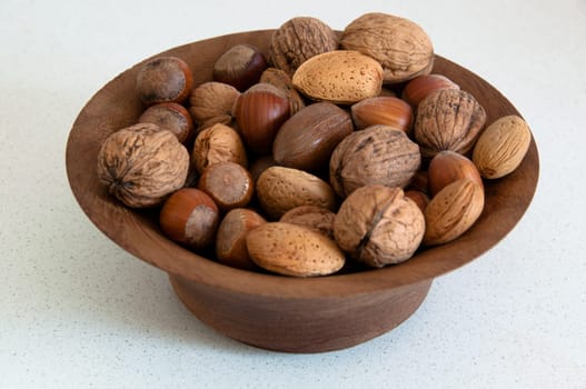 assortment of several kind of nuts in a wooden bowl