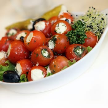 Small cherry tomatoes with cheese filling at the buffet - close-up - square copy space