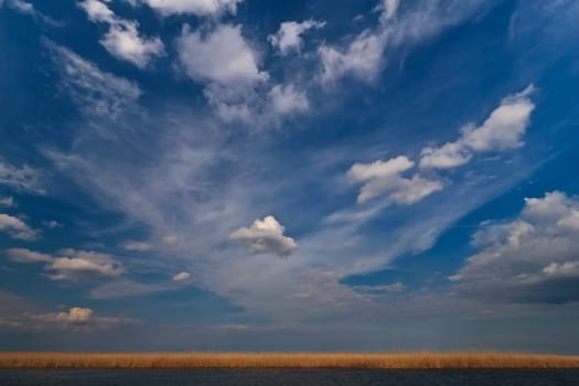 clouds over the lake and a blue sky