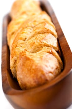 Isolated sliced baguette bread in wooden dish