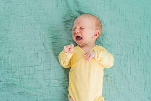 A newborn baby cries while lying on a soft muslin swaddle, expressing emotions and seeking comfort. A tender and natural moment of early infancy, symbolizing vulnerability, needs, and parental care.