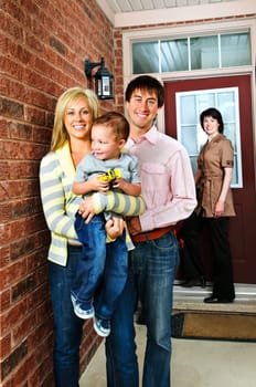 Real estate agent with family welcoming to new home