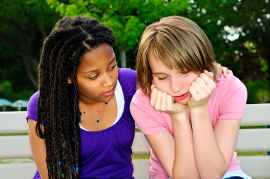 Teenage girl consoling her sad upset friend