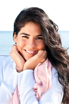 Portrait of beautiful smiling native american girl with hands at her face