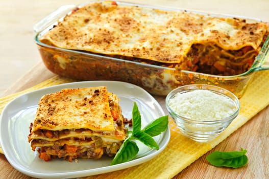 Fresh baked lasagna casserole with a serving cut